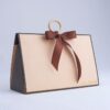 Vintage beige triangular hand-held cosmetic gift box with wooden ring and bow