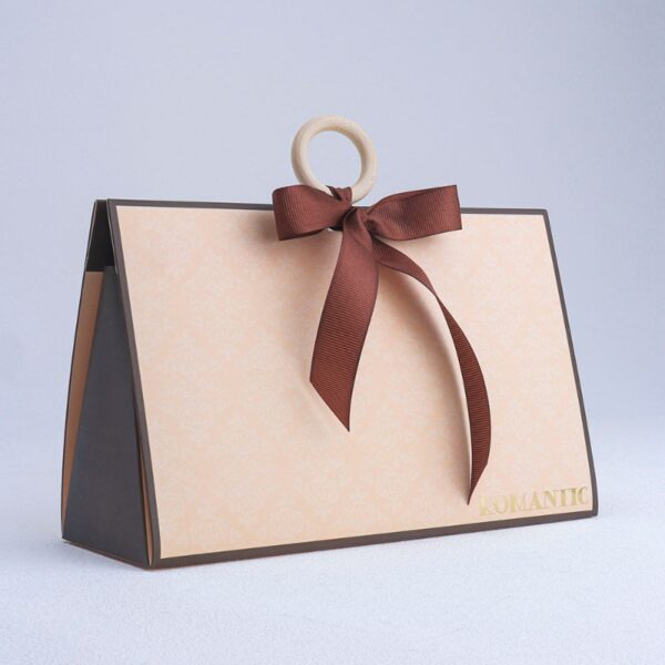 Vintage beige triangular hand-held cosmetic gift box with wooden ring and bow