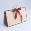 Vintage beige triangular hand-held cosmetic gift box with wooden ring and bow